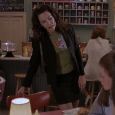 a woman standing at a counter in a restaurant