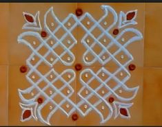 an intricately designed white tile with red accents