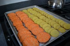 there are many orange and yellow cookies in the pan on the stove top, ready to be baked