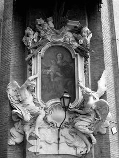 an ornate painting on the side of a building with angels and cherubs around it