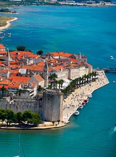 an aerial view of the old city walls and its surrounding area, with boats in the water