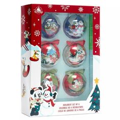 four christmas ornaments in a box with snowflakes and santa's helpers