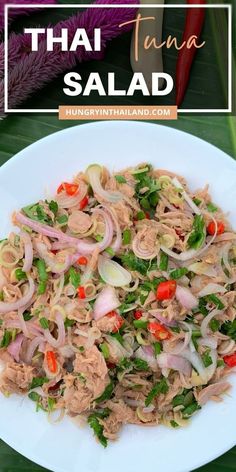 thai salad with tuna and vegetables on a white plate