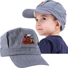 a young boy wearing a hat with a train embroidered on the front and side of it