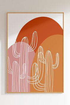 an orange and pink cactus print hangs on the wall