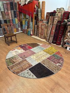 a round rug with many different colors and designs on it in a room full of books