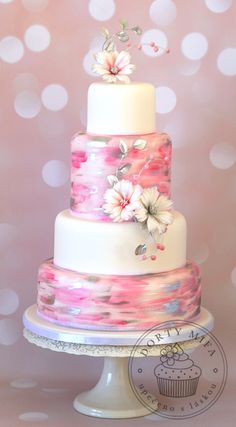 a three tiered cake with flowers on the top is displayed in an instagramtion