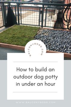 an outdoor dog potty with rocks and grass in the ground, next to a fence