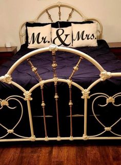 a bed with two pillows on top of it next to a pillow that says mr and mrs