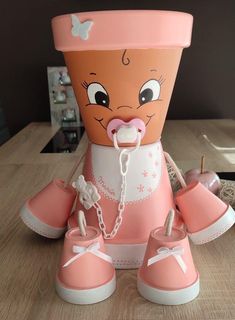 a pink and white toy with shoes on it