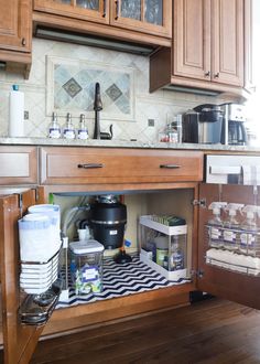 an open cabinet in the middle of a kitchen