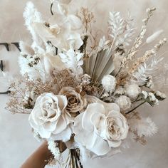 a vase filled with lots of white flowers