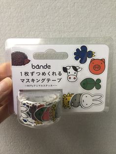 someone is holding up a package of washi tape with animals on the front and back