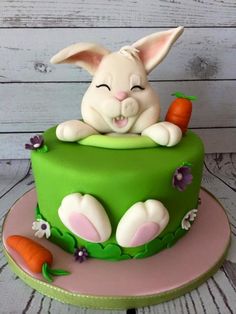 there is a cake with a rabbit on it and carrots in the middle of it