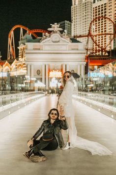 two brides pose for a photo in front of the las vegas hotel and casino