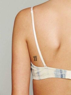 the back of a woman's bra with tattoos on it