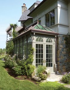 a house with a green roof and windows