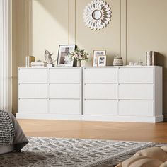 a white dresser sitting next to a bed in a bedroom on top of a hard wood floor