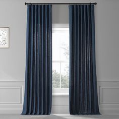 a blue curtain hanging in front of a window with an open valil and white walls