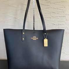 ~Nwt~ Coach City Tote In Black Leather 72673 Pristine Nwt Coach City Tote In Black Leather; Two Straps.Beautiful Smooth Oxblood Interior. Heavy Brass Hang Tag - No Scratches Or Surface Wear. Magnetic Closure. Inside Zip Pocket. Protective Wraps On Zipper Pull And One Side Of Magnet, As Well As Protective Foam Under The Creed Patch. Gold Metal Pinmounted Logo On Exterior And Interior Please See Photos For Measurements. Please Message Me With Any Questions. I Usually Ship Within One Day, Or Ship Within Two Days At The Most. City Tote, Black Leather, Nwt, Carry On, Travel, Work, Work Bag, Weekend, Weekender, Travel, Classic, Leather, Winter, Spring, Summer, Fall, Modern, Feminine, Vac Coach City Tote, Carry On Travel, City Tote Bag, Black Poppy, Coach Tote Bags, Modern Feminine, White Tote, Brown Handbag, Travel Work