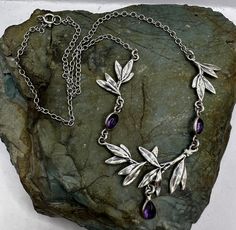 Sterling Silver and Amethyst Leaf Detail Necklace 2mm Chain 16". Marked 925. Condition is very good, scuffs and scratches on the surface from wear.  Thank you for looking! Prices on shop items are fair and reasonable, so all prices are firm.  No reserves, all items sold as-is. Please review photos and description carefully before purchasing.  Please let me know of you have any questions or special shipping requests such as postal insurance.  Once an item is shipped and tracking is available, we are no longer responsible. All inquiries regarding tracking and delivery should be sent to USPS.   We are a licensed gold and silver buyer in the state of California; all of our items are tested for purity and authenticity. Necklaces, Detailed Necklace, Gold And Silver, Pendant Necklaces, Jewelry Necklace Pendant, Insurance, Amethyst, Jewelry Necklaces, Let Me