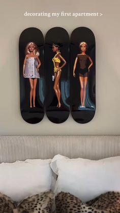 there are three barbie dolls on the wall