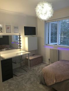 a bedroom with a bed, desk and mirror