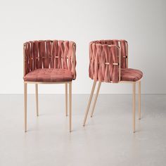 two pink chairs sitting next to each other