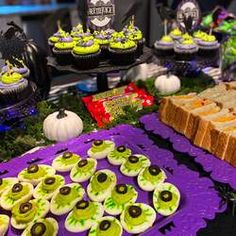 a table topped with lots of different types of food and desserts on top of it