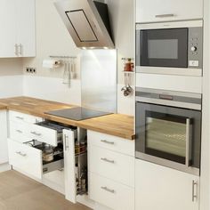 a kitchen with white cabinets and an oven