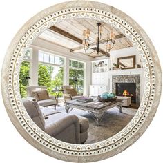 a living room filled with furniture and a fire place under a chandelier above a fireplace