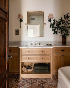 a bathroom with a sink, mirror and bathtub