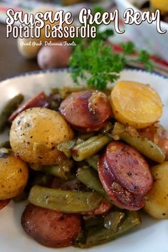 sausage, green bean and potato casserole on a white plate with parsley