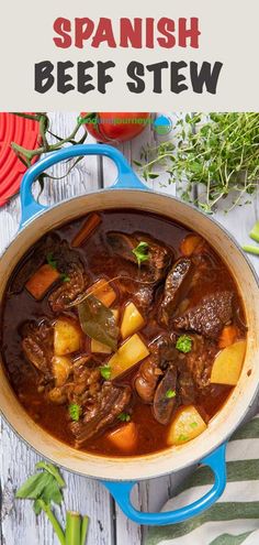 beef stew in a blue pot on a white wooden table with red plates and green garnish