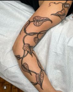 a woman's arm with tattoos on it and flowers growing out of the side