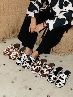 🐄 The classic LSG Dakota Clog returns! The super comfy and versatile Dakota adds a unique touch to any outfit. Details A cow print clog shoe with a flat platform, made with a soft faux pony hair upper.Faux pony hair upper and flatformRecycled padded leather lining Elastic insert at the strap for extra comfort Made at a woman owned and run factory in China  US sizingFits true to sizeFeatures a 2" platform Leather Clogs For Women, Cow Print Shoes, Mules Outfit, Shoe Outfits, Clog Shoe, Clogs For Women, Lisa Says Gah, Black Cow, Print Shoes