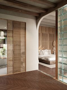 a bedroom with wooden floors and walls, along with a glass door leading to the bed