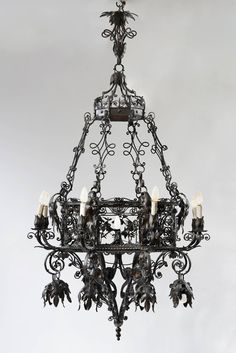 an ornate chandelier with candles hanging from it's center and four arms