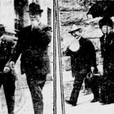 an old black and white photo of two men walking down the street with umbrellas