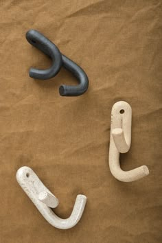 two black and white objects laying on top of brown paper