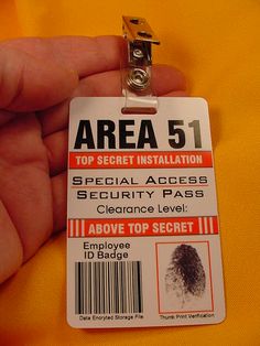 a hand holding an area 51 id badge