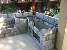 cinder blocks are stacked into the shape of a house in an outdoor area that is being built