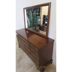 a dresser with a mirror on top of it