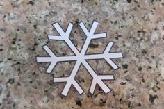 a white snowflake sitting on top of a granite counter