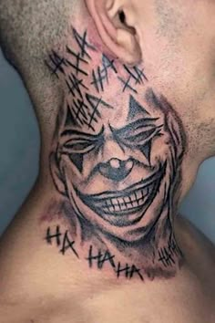 a man's neck with a clown face tattoo on the back of his head