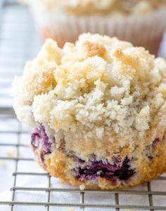 blueberry muffins sitting on top of a cooling rack