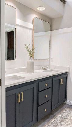 a bathroom with two sinks and a large mirror