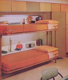 a bunk bed with orange sheets and pillows in a room that has yellow furniture on it