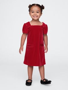 Soft, stretch velour dress.  Square neck with back button closures.  Short puff sleeves.  Bow details at front.  Front welt pockets.  This dress is made with 95% recycled polyester.  Compared to virgin materials, using recycled materials helps to reduce resource use and waste.  Shift silhouette with an easy fit.  Hits at the knee.  Sizes range from baby to toddler. Christmas Party Attire, Toddler Christmas Dress, Dress Square Neck, Party Attire, Velour Dress, Chunky Knitwear, Newborn Dresses, Formal Shirts For Men, Wide Fit Boots