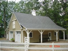 a small house with a white fence around it